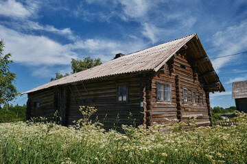 Fototapeta na wymiar One of the most beautiful villages of Karelia Kinerma in summer. The old wooden house has been well preserved to our time. The concept of travel in Russia.