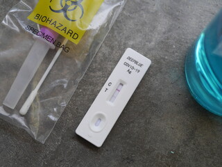 Antigen test kit showing results of testing for COVID-19  test result is positive
