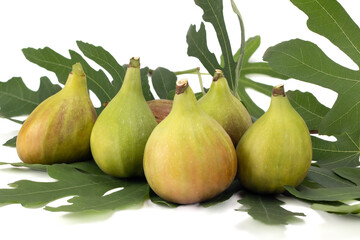 Ripe sweet figs. Fresh figs with leaves isolated on bright background. Close up view.