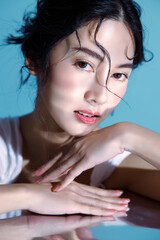 Attractive young wet hair Asian woman model with perfect fresh skin on underwater simulation of...