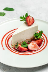 delicious homemade strawberry cheesecake with fresh strawberries, jam and mint