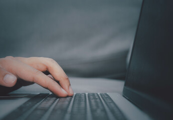 Man presses his finger on a button on a laptop.Business internet technology concept.