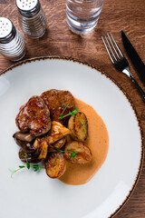 medallions of beef with baked mini potatoes with mushrooms