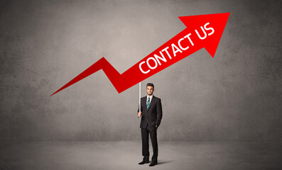 Young business person in casual holding road sign