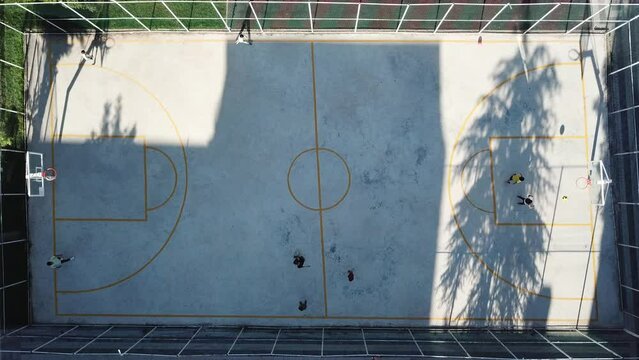 Aerial view of the kids are playing game on basketball court.