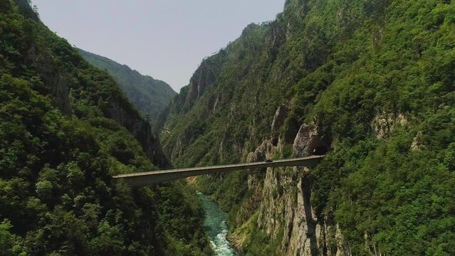 Aerial video. Shooting a beautiful gleby gorge and bridge on a sunny summer day