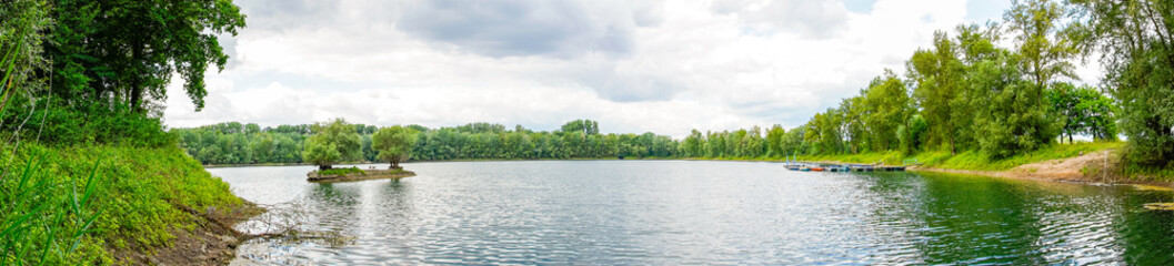 Fototapeta premium Rohrhofer See near Bruehl. Lake with surrounding nature in Baden-Württemberg. 