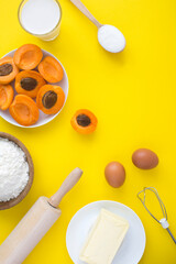 Top view of ingredients for making apricot pie or cake on the yellow  background. Copy space. Location vertical.