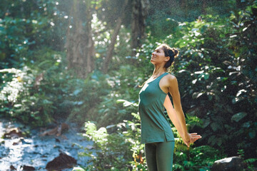 European girl doing yoga and walking in nature.