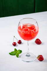 Aperol Spritz aperitif with oranges and ice cubes in glass on white table. Summer refreshing drink concept
