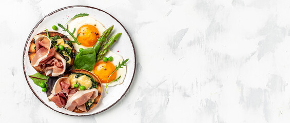 Delicious breakfast or snack. Grilled Toast witch Asparagus, fried egg, bacon jamon, ham, prosciutto on light background. Healthy fats, clean eating for weight loss. top view
