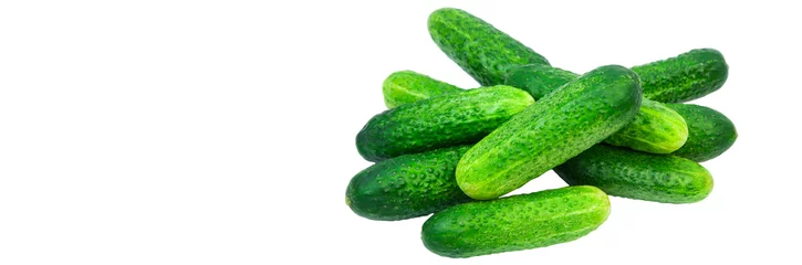 Crédence de cuisine en verre imprimé Légumes frais green cucumbers on a white background. ripe gherkins on a table. fresh vegetables on a light texture. the concept of growing cucumbers