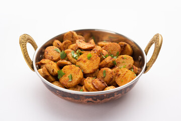 Stir fried taro roots. Arbi ki sabji, ghuiya masala curry Sabzi or arvi dum Masala. Garnished with coriander