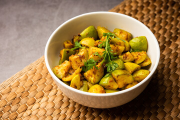 Indian style Tinda or Tinde ki Sabzi also called Indian squash, round melon, Indian round gourd or Indian baby pumpkin, stuffed, stir fried dry or curry recipe