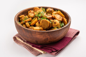 Stir fried taro roots. Arbi ki sabji, ghuiya masala curry Sabzi or arvi dum Masala. Garnished with coriander