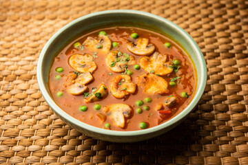 Mushroom and Pea Curry with Roasted Garlic, Indian food served in a bowl