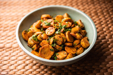 Stir fried taro roots. Arbi ki sabji, ghuiya masala curry Sabzi or arvi dum Masala. Garnished with coriander