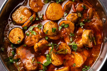 Stir fried taro roots. Arbi ki sabji, ghuiya masala curry Sabzi or arvi dum Masala. Garnished with coriander
