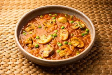 Mushroom and Pea Curry with Roasted Garlic, Indian food served in a bowl