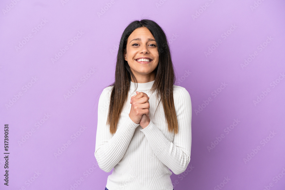 Wall mural Young caucasian woman isolated on purple background laughing