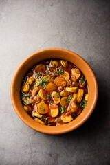 Stir fried taro roots. Arbi ki sabji, ghuiya masala curry Sabzi or arvi dum Masala. Garnished with coriander