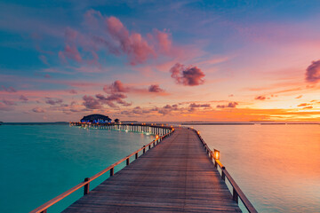 Beautiful Maldives paradise sunset. Tropical aerial landscape, seascape, water villas amazing sea...