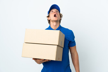 Delivery man over isolated white background looking up and with surprised expression