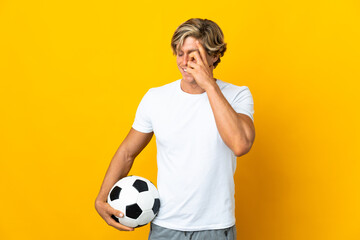 English football player over isolated yellow background laughing