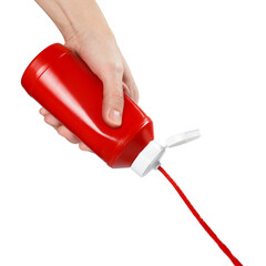 Hand squeezing ketchup out of a plastic bottle, isolated on white background
