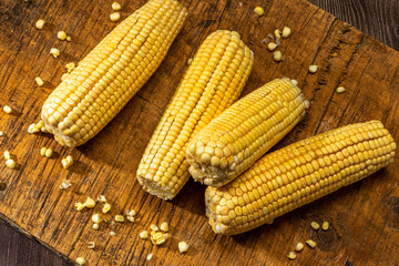 Corn on the cob on rustic wooden background.