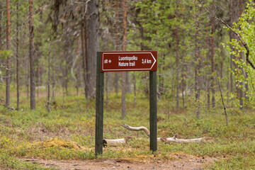 Signpost on the hiking trail in Lemmenjoki National Park in Finland.