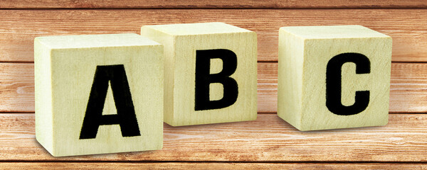 A B C letters on wooden cubes - obrazy, fototapety, plakaty