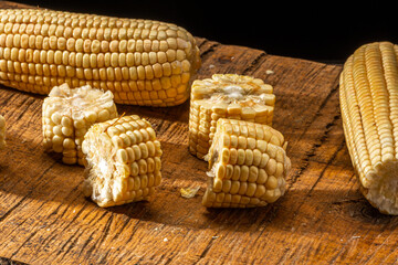 Corn on the cob on rustic wooden background.