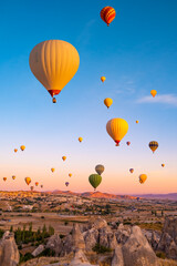 Hot air balloons flying on sunset sky in Cappadocia, Turkey - obrazy, fototapety, plakaty