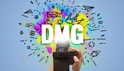 Close-up of a hand holding digital camera with abstract drawing