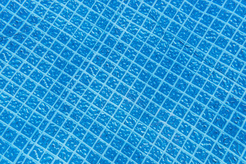 Background made from the bottom of a garden pool, visible rubber bottom in squares.