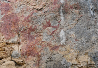 Ancient cliff wall painting of an animals. The archaeological site of color paintings of Pratu Pha Valley of Lampang, Thailand.