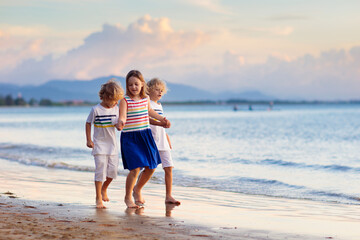 Kids play on tropical beach. Sand and water toy.