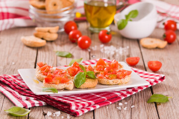 Friselle with cherry tomatoes and basil.