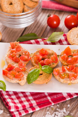 Friselle with cherry tomatoes and basil.