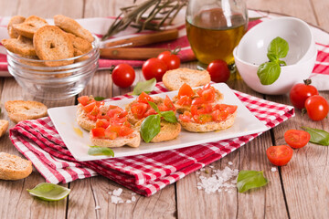 Friselle with cherry tomatoes and basil.