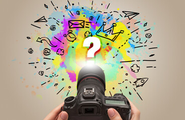 Close-up of a hand holding digital camera with abstract drawing concept concept