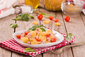 Ruote pasta with tomato and ham.