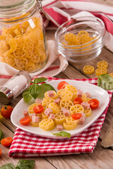 Ruote pasta with tomato and ham.