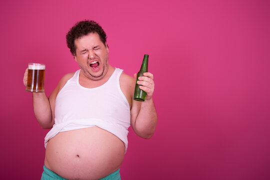 Funny Fat Man Drinks Light Beer.	