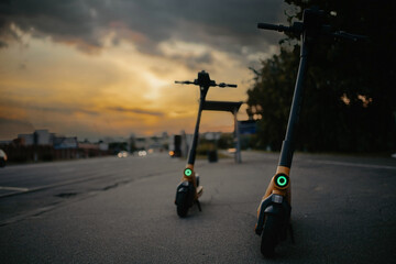 rental electric scooters in the city in the evening, LED light.