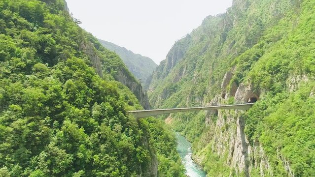 Aerial video. Shooting a beautiful gleby gorge and bridge on a sunny summer day