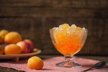 Summer Sicilian dessert granita, frozen fruit juice apricots, peaches, nectarines on a wooden background. Summer cooling, tonic cocktail of crushed ice, a kind of sherbet.