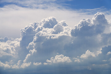 A beautiful cluster of voluminous cumulus forms in the sky before the rain. Natural background. Shooting from a drone. Copy space.