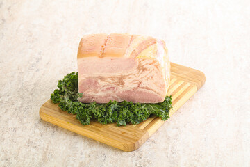 Cut of pork bacon over board